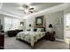 Comfortable main bedroom with a tray ceiling, shuttered windows, a ceiling fan, and carpet flooring at 115 Thornwhistle Pl, Garner, NC 27529