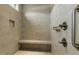 Modern shower with neutral tile, built-in bench, a handheld shower, and a recessed shelf at 115 Thornwhistle Pl, Garner, NC 27529