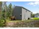 View of back of house with deck, lawn, and play equipment at 120 Rocking Horse Ln, Sanford, NC 27332