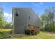 Back exterior showing a deck and wooded area with yard at 120 Rocking Horse Ln, Sanford, NC 27332