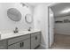 Modern bathroom with dual sinks, round mirrors, black fixtures, and recessed lighting at 120 Rocking Horse Ln, Sanford, NC 27332