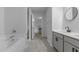 Bright and modern bathroom with a double vanity, soaking tub, and tiled floors at 120 Rocking Horse Ln, Sanford, NC 27332
