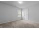 Cozy bedroom with a window and light-colored walls and carpet at 120 Rocking Horse Ln, Sanford, NC 27332