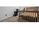 Cozy bedroom with neutral carpet and furniture, featuring a bed and a desk under the window at 120 Rocking Horse Ln, Sanford, NC 27332