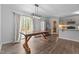 Cozy dining area with hardwood floors, a wooden table, and sliding glass doors that lead to an outdoor deck at 120 Rocking Horse Ln, Sanford, NC 27332