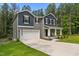 Charming two-story home with a covered front porch, a two-car garage, and a well-manicured lawn at 120 Rocking Horse Ln, Sanford, NC 27332