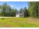 Charming home with a well-manicured lawn and a spacious driveway, surrounded by lush trees at 120 Rocking Horse Ln, Sanford, NC 27332