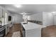 Modern kitchen featuring an island with a sink, stainless steel appliances, and wood flooring at 120 Rocking Horse Ln, Sanford, NC 27332