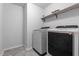 Modern laundry room with new front loading washer and dryer and a shelf at 120 Rocking Horse Ln, Sanford, NC 27332