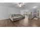 Open concept living space with hardwood floors, a gray couch, and an adjacent dining area and kitchen at 120 Rocking Horse Ln, Sanford, NC 27332