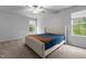 Well-lit bedroom with a ceiling fan and large windows bringing in natural light at 120 Rocking Horse Ln, Sanford, NC 27332