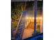 Enchanting nighttime view of a wooden deck and brick patio, illuminated by string lights at 12212 Ashton Woods Ln, Raleigh, NC 27614