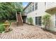 Backyard patio with fountain, wooden stairs to deck, and view of landscaped garden at 12212 Ashton Woods Ln, Raleigh, NC 27614