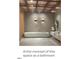 Modern bathroom boasts a sleek, minimalist tub, floating vanity, and unique sconce lighting at 12212 Ashton Woods Ln, Raleigh, NC 27614