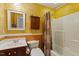 Cozy bathroom features wood accents, vanity, toilet and shower with bathtub at 12212 Ashton Woods Ln, Raleigh, NC 27614