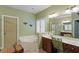 Well-lit bathroom with a soaking tub, vanity with sink, and stylish fixtures at 12212 Ashton Woods Ln, Raleigh, NC 27614