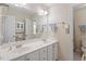 Bright bathroom features double sinks, large mirror, and a white vanity at 12212 Ashton Woods Ln, Raleigh, NC 27614
