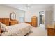 Well-lit bedroom with a floral bedspread and classic wooden furniture at 12212 Ashton Woods Ln, Raleigh, NC 27614