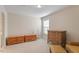 This simple bedroom features a window, wicker storage, and furniture at 12212 Ashton Woods Ln, Raleigh, NC 27614