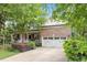 Charming brick home featuring a well-manicured lawn and a welcoming front porch with a two-car garage at 12212 Ashton Woods Ln, Raleigh, NC 27614