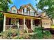 Charming two-story brick home featuring a welcoming front porch and beautiful landscaped yard, plus an attached garage at 12212 Ashton Woods Ln, Raleigh, NC 27614
