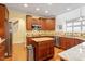 Well-lit kitchen showcasing a center island, stainless steel appliances and wooden cabinetry at 12212 Ashton Woods Ln, Raleigh, NC 27614