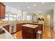 Spacious kitchen with stainless appliances, wood cabinets, granite countertops, and a kitchen island at 12212 Ashton Woods Ln, Raleigh, NC 27614