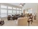 Bright and airy living room with large windows, neutral decor, and ceiling fan at 12212 Ashton Woods Ln, Raleigh, NC 27614