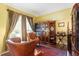 Cozy living room with leather seating, built-in bookcase, hardwood floors and natural light at 12212 Ashton Woods Ln, Raleigh, NC 27614