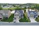 Aerial view of home with manicured lawn and tranquil pond in a peaceful neighborhood setting at 123 Claystone Dr, Gibsonville, NC 27249