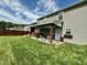 Spacious backyard with a covered patio, lush lawn, privacy fence, and beautiful landscaping at 123 Claystone Dr, Gibsonville, NC 27249