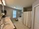 Well-lit bathroom with a double sink vanity, soaking tub, and separate shower area at 123 Claystone Dr, Gibsonville, NC 27249