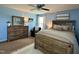 Cozy bedroom with a wooden bed frame, blue walls, and a ceiling fan at 123 Claystone Dr, Gibsonville, NC 27249