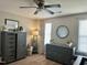 Inviting bedroom featuring a wood dresser, decorative accents, and soft lighting at 123 Claystone Dr, Gibsonville, NC 27249
