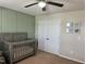 Neutral Bedroom features a gray crib and accent wall, offering a serene atmosphere at 123 Claystone Dr, Gibsonville, NC 27249
