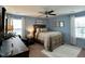 Bedroom with wood-framed bed and matching furniture, soft blue walls, and ample natural light at 123 Claystone Dr, Gibsonville, NC 27249