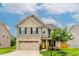 Charming two-story home features a brick and siding exterior with a well-manicured lawn at 123 Claystone Dr, Gibsonville, NC 27249
