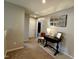 Bright hallway with carpeted floor, features a table with decor, a doorway, and a mirror at 123 Claystone Dr, Gibsonville, NC 27249