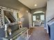 Welcoming hallway view with stairs, decorative mirror, console table and arched entryway into the living room at 123 Claystone Dr, Gibsonville, NC 27249