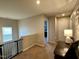 Bright hallway featuring a window, railing, doorway, and convenient access to other areas of the home at 123 Claystone Dr, Gibsonville, NC 27249