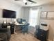 This home office offers a desk, chair and cabinets for storage with a large screen TV on the wall at 123 Claystone Dr, Gibsonville, NC 27249