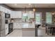 Bright kitchen with white cabinets, stainless steel appliances, subway tile backsplash, and spacious island at 123 Claystone Dr, Gibsonville, NC 27249