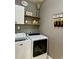 Well-organized laundry room features modern washer and dryer, floating shelves, and decor at 123 Claystone Dr, Gibsonville, NC 27249