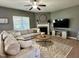 Spacious living room with a comfortable sectional sofa, fireplace, and neutral decor at 123 Claystone Dr, Gibsonville, NC 27249