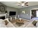 Cozy living room featuring a large sectional, fireplace, and stylish decor elements at 123 Claystone Dr, Gibsonville, NC 27249
