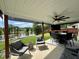 Relaxing covered patio with pond view, outdoor furniture, and ceiling fan at 123 Claystone Dr, Gibsonville, NC 27249
