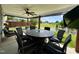 Covered patio with elegant dining furniture, ceiling fan, and scenic pond views at 123 Claystone Dr, Gibsonville, NC 27249