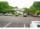 Apartment building featuring a parking lot with several parked vehicles and landscaping at 1301 Durlain Dr # 103, Raleigh, NC 27614