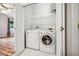 Convenient laundry closet with washer and dryer unit, and built-in shelving at 1301 Durlain Dr # 103, Raleigh, NC 27614