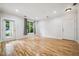Spacious living room with wood floors, bright windows, and neutral walls at 1301 Durlain Dr # 103, Raleigh, NC 27614
